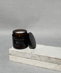 Earth candle with the lid off, showing the cotton wick and natural soy wax
